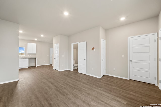 unfurnished living room with dark hardwood / wood-style flooring