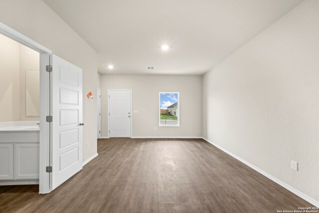 unfurnished room with sink and dark hardwood / wood-style floors