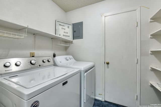 washroom featuring electric panel, independent washer and dryer, and a textured ceiling