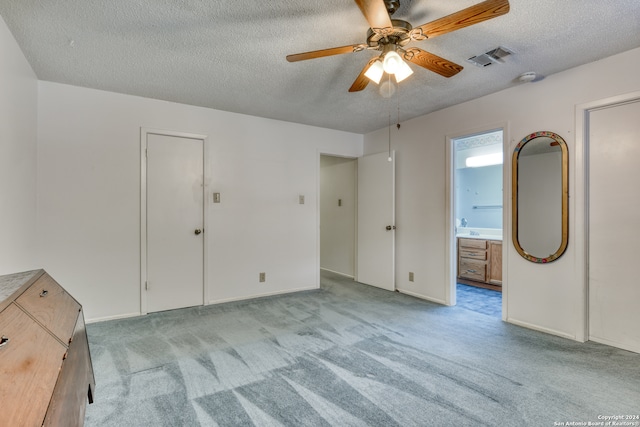 carpeted empty room featuring a textured ceiling and ceiling fan