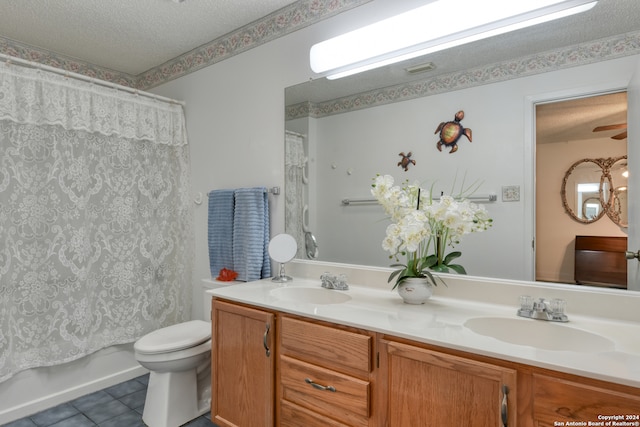 full bathroom with shower / bath combo with shower curtain, toilet, tile patterned flooring, a textured ceiling, and vanity