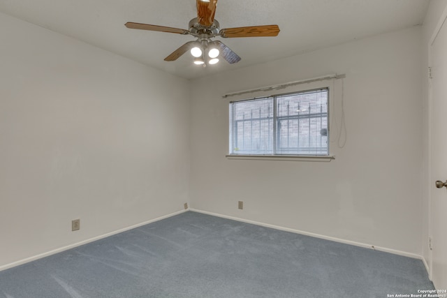 unfurnished room featuring dark colored carpet and ceiling fan