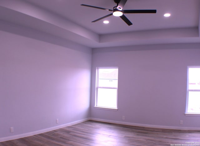 unfurnished room featuring hardwood / wood-style flooring, plenty of natural light, and ceiling fan