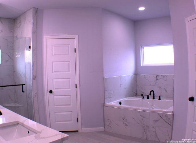 bathroom with shower with separate bathtub and vanity