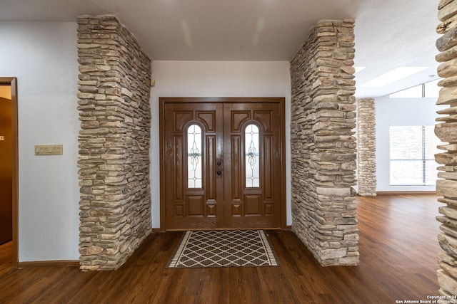 foyer entrance featuring dark hardwood / wood-style flooring and a textured ceiling