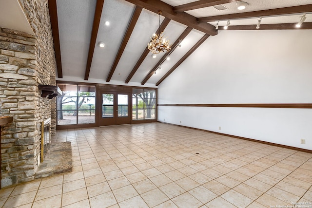 unfurnished living room featuring a stone fireplace, a notable chandelier, light tile patterned floors, beam ceiling, and high vaulted ceiling