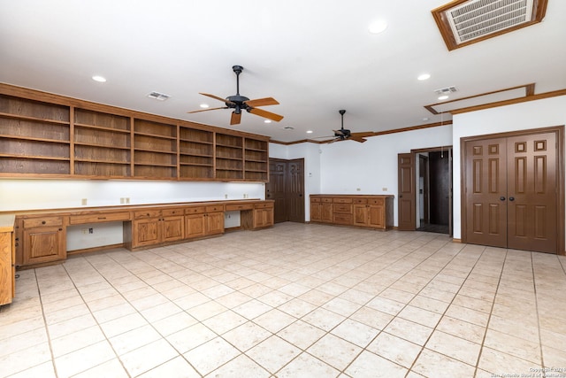 kitchen with light tile patterned floors, built in desk, crown molding, and ceiling fan