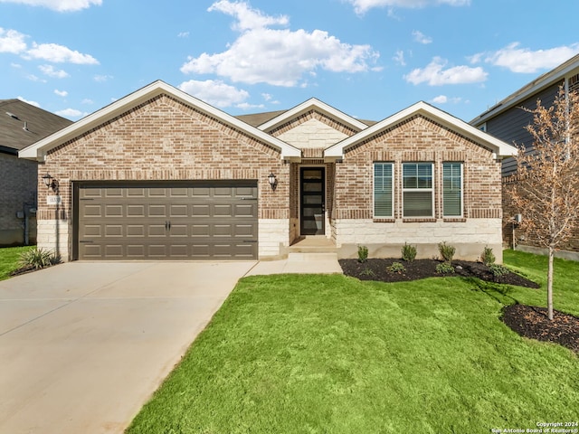 view of front of home with a front yard and a garage