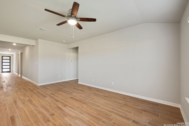 spare room with ceiling fan, lofted ceiling, and light hardwood / wood-style flooring