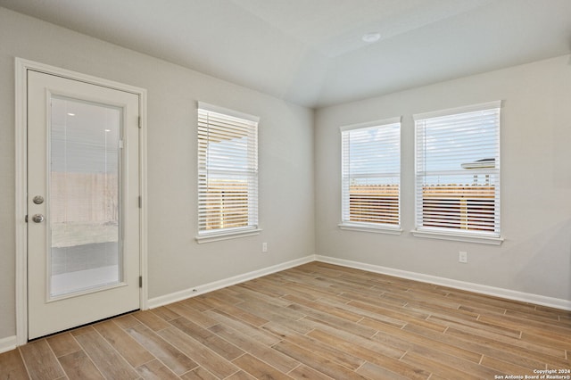 empty room with plenty of natural light and light wood-type flooring