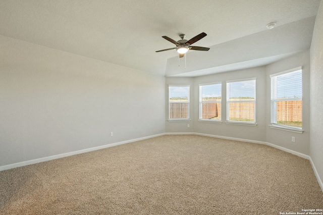 spare room with carpet flooring, ceiling fan, and lofted ceiling