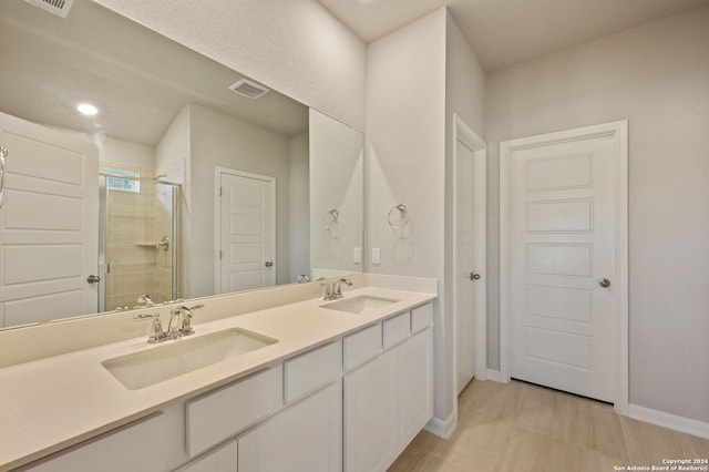 bathroom featuring vanity and a shower with door