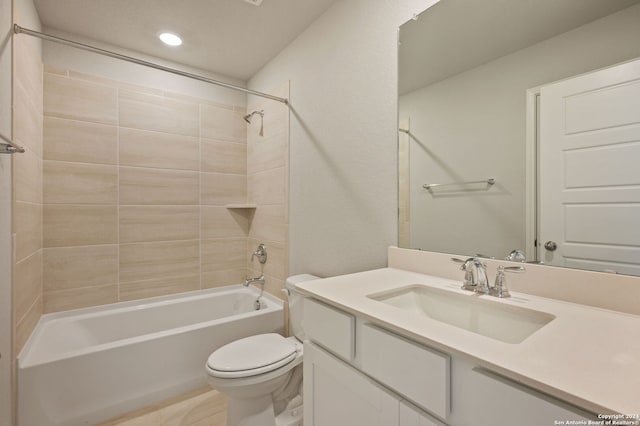 full bathroom with tile patterned floors, vanity, toilet, and tiled shower / bath combo