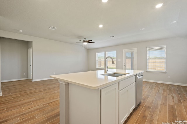 kitchen with ceiling fan, sink, stainless steel dishwasher, an island with sink, and white cabinets