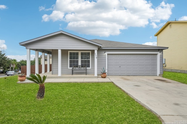 view of front of house with a garage, a front lawn, and covered porch