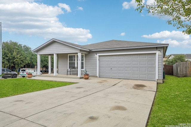 ranch-style home featuring a garage, a front yard, and a porch