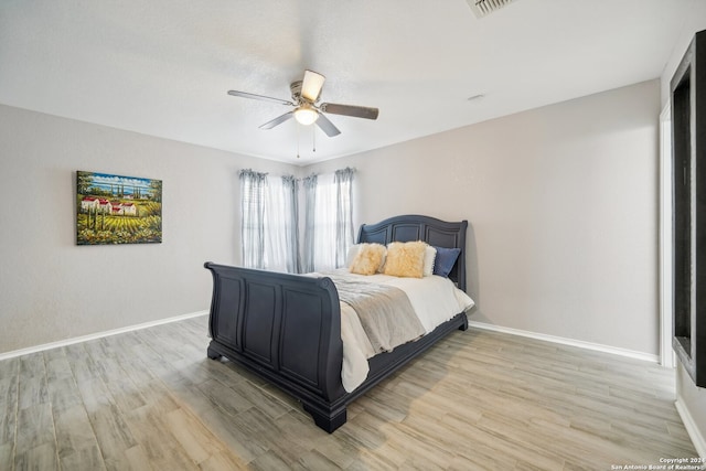 bedroom with ceiling fan and light hardwood / wood-style flooring