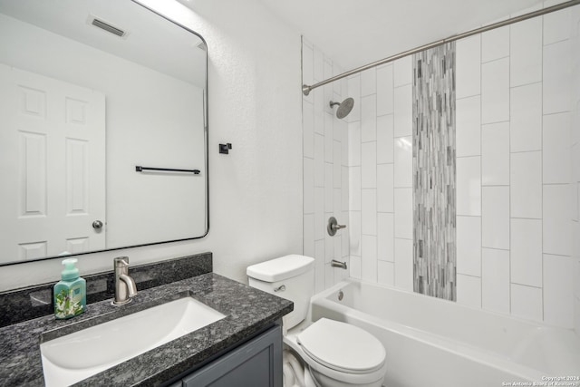 full bathroom with toilet, tiled shower / bath combo, and vanity