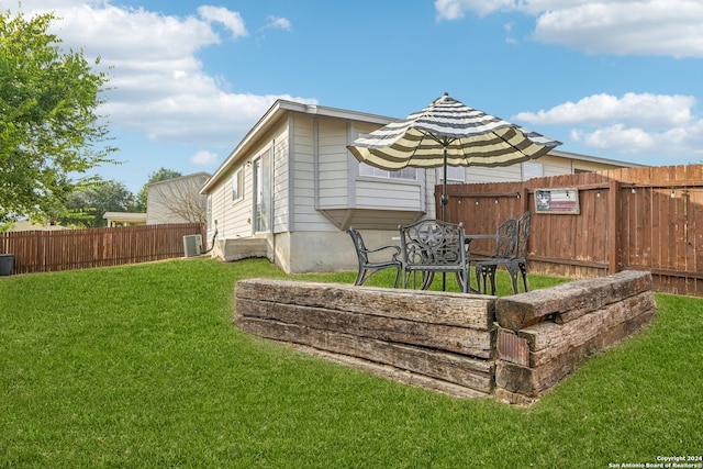 exterior space featuring central air condition unit and a lawn