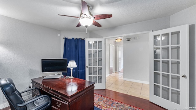 tiled office featuring a textured ceiling, french doors, and ceiling fan