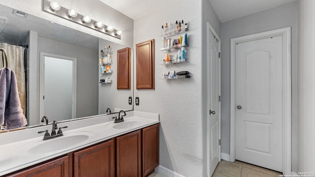 bathroom with vanity and tile patterned floors