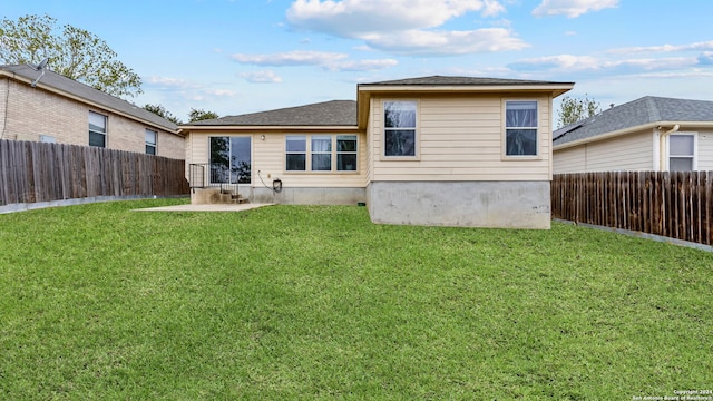 back of property with a patio and a yard