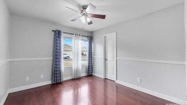 spare room featuring ceiling fan, a textured ceiling, and dark hardwood / wood-style floors