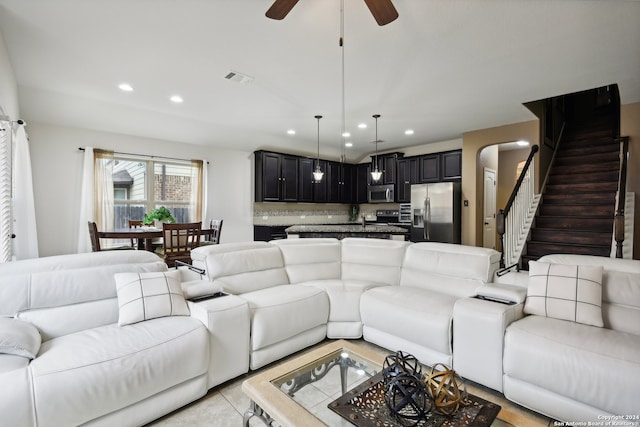 tiled living room with ceiling fan