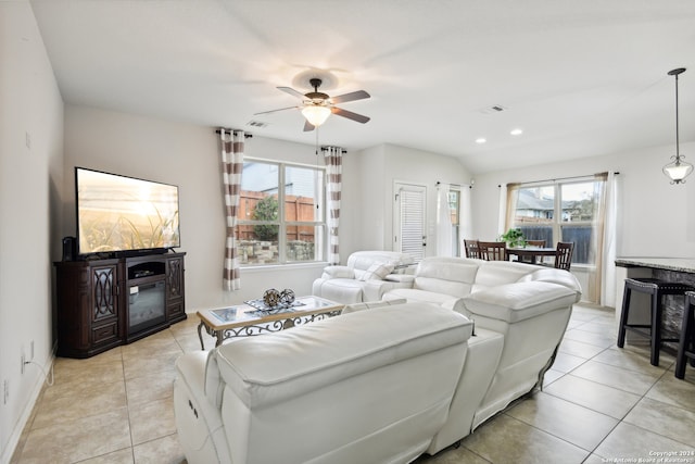 living room with a wealth of natural light, light tile patterned floors, and ceiling fan