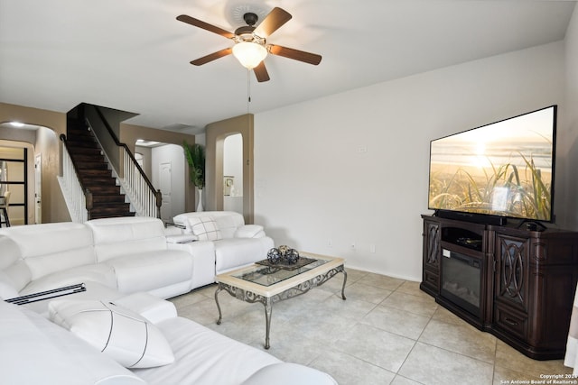 tiled living room featuring ceiling fan