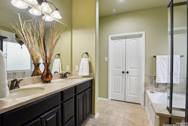 bathroom featuring tile patterned flooring, vanity, and a bathtub