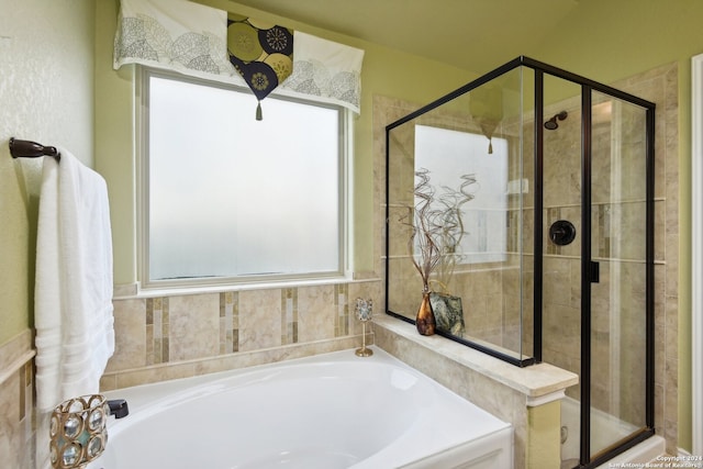 bathroom featuring shower with separate bathtub