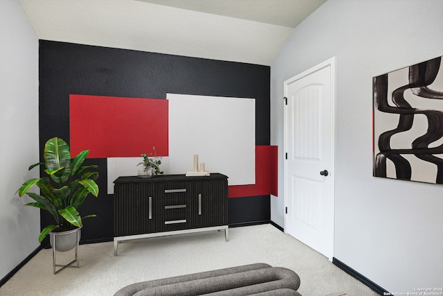 sitting room with lofted ceiling and carpet