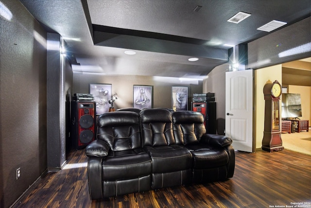 home theater featuring dark hardwood / wood-style floors and a textured ceiling