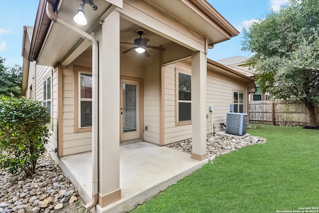 exterior space with central air condition unit, ceiling fan, a yard, and a patio area