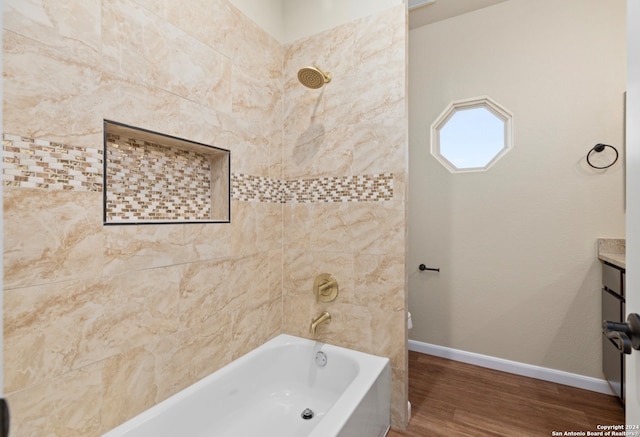 bathroom with tiled shower / bath combo, vanity, and hardwood / wood-style floors