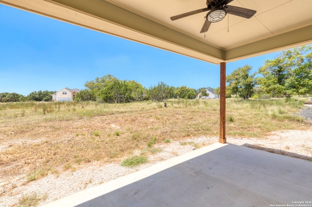 view of yard with ceiling fan