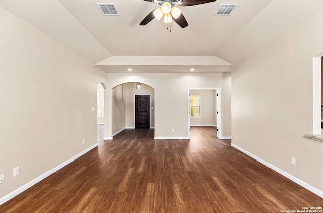 unfurnished living room featuring lofted ceiling, dark hardwood / wood-style floors, and ceiling fan