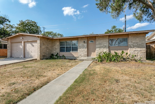 ranch-style home featuring a front yard and a garage