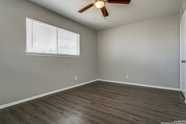 empty room with dark wood-type flooring and ceiling fan