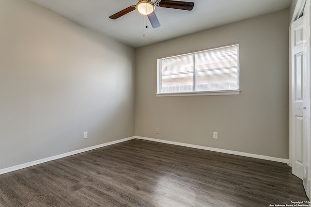 spare room with ceiling fan and dark hardwood / wood-style flooring