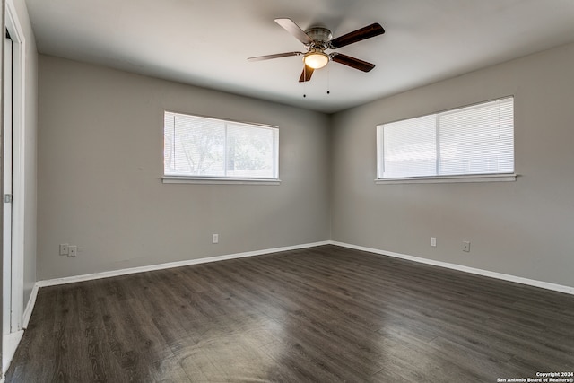 unfurnished room with dark wood-type flooring and ceiling fan