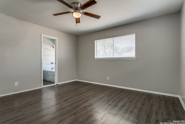 spare room featuring dark wood-type flooring and ceiling fan