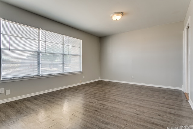 empty room with dark wood-type flooring