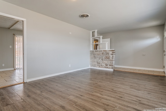 unfurnished living room with hardwood / wood-style flooring