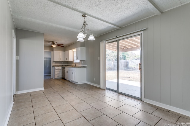 kitchen with ceiling fan with notable chandelier, white cabinets, sink, light tile patterned floors, and decorative light fixtures