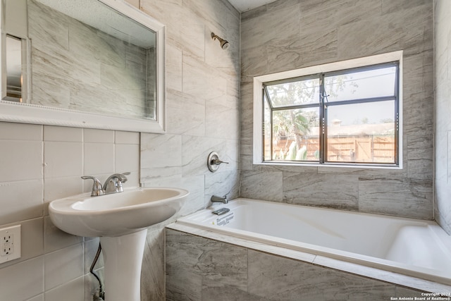 bathroom featuring tiled shower / bath and tile walls