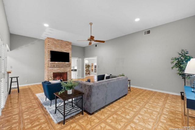 living room with ceiling fan and a brick fireplace