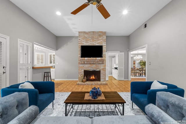 living room featuring a brick fireplace and ceiling fan