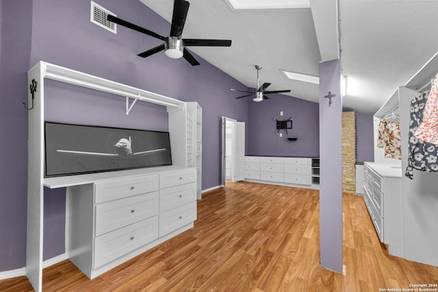 unfurnished living room with light hardwood / wood-style floors, ceiling fan, and vaulted ceiling